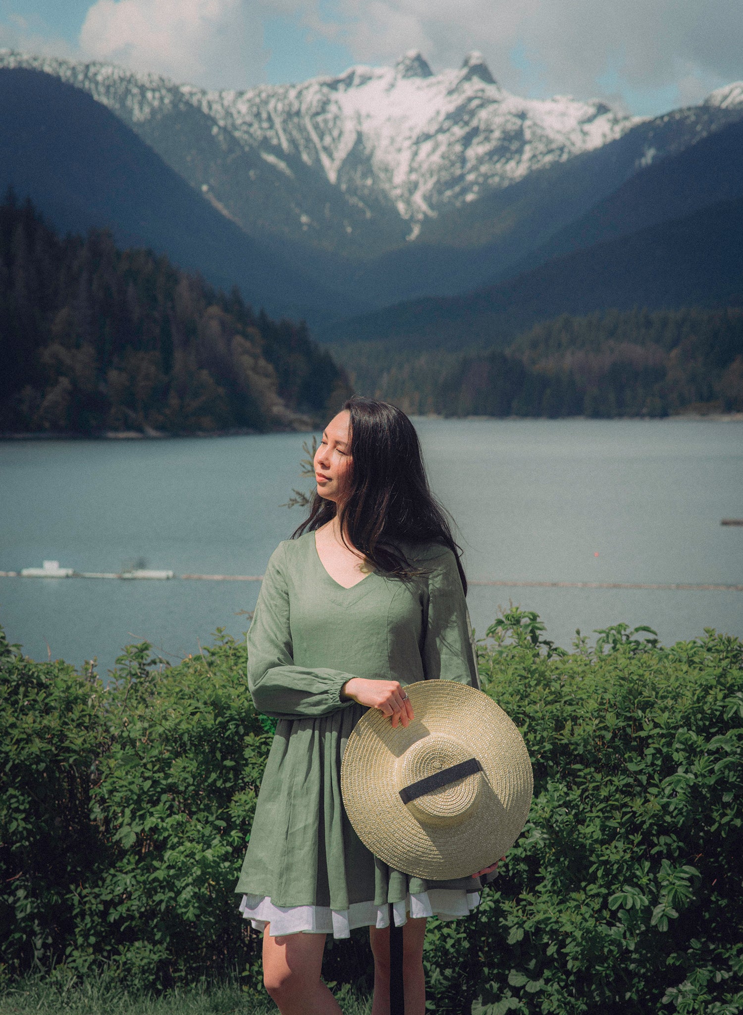 Beautiful black hair girl on a mountain background wearing the Wandwoods green dress with long sleeves, short skirt and white trim